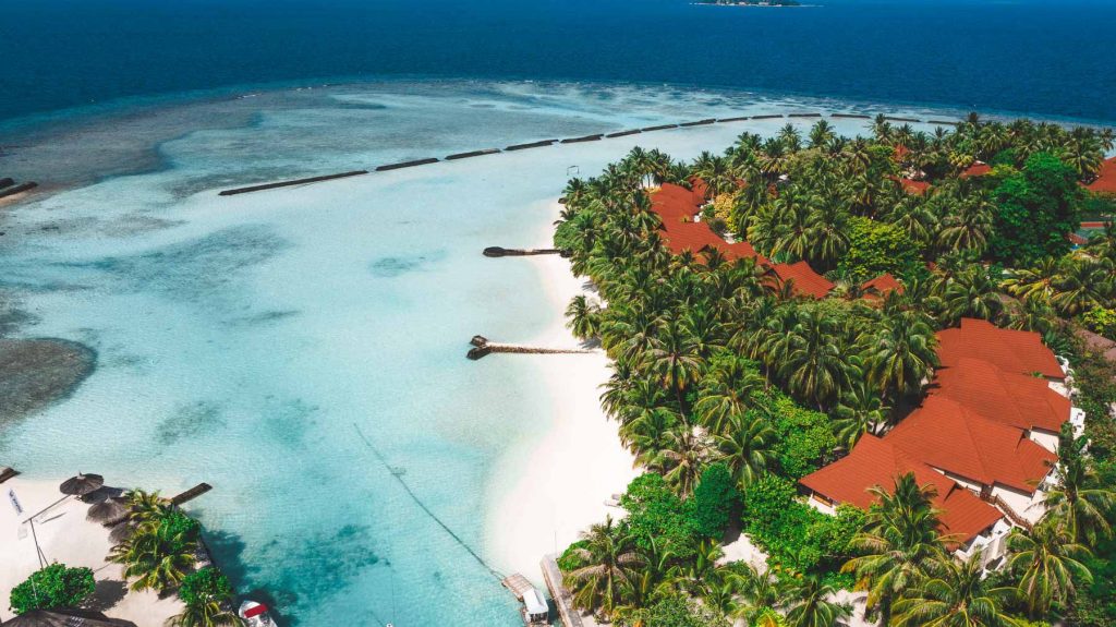 The typical houses among the palm trees on the island of Kurumba, North Malè Atoll
